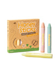 Honey Sticks beeswax crayons with packaging on a beige background