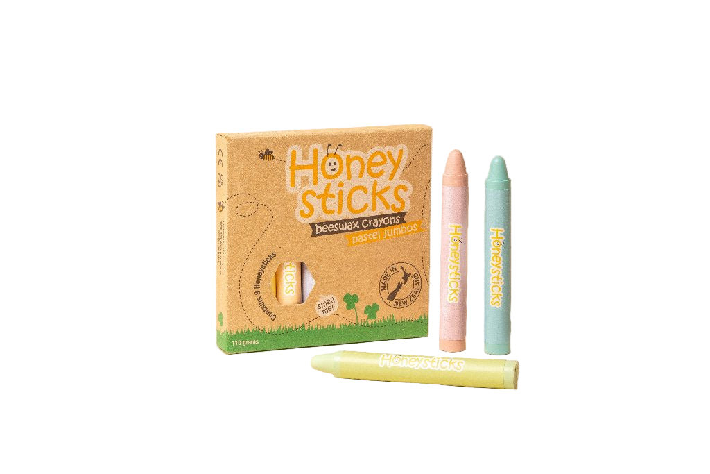 Honey Sticks beeswax crayons with packaging on a beige background