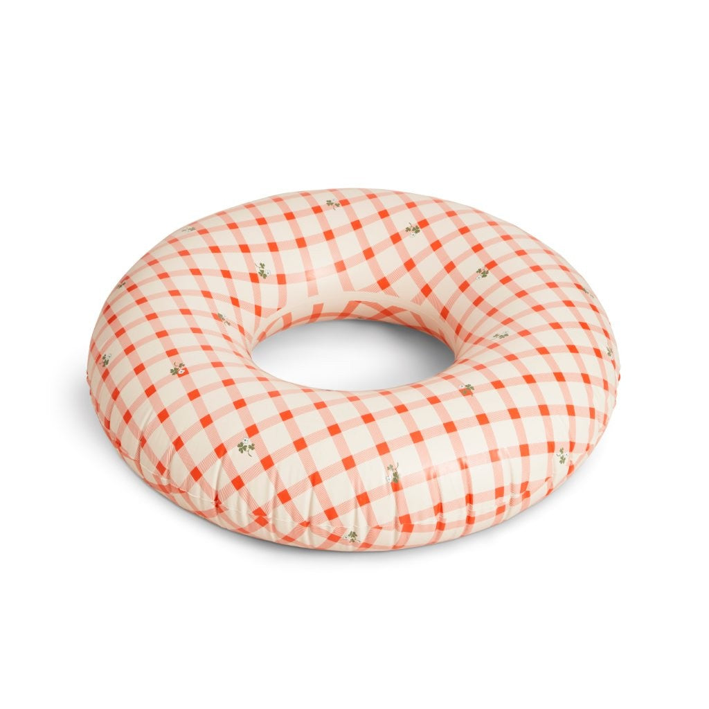 Checkered donut pillow with red and white pattern on a white background